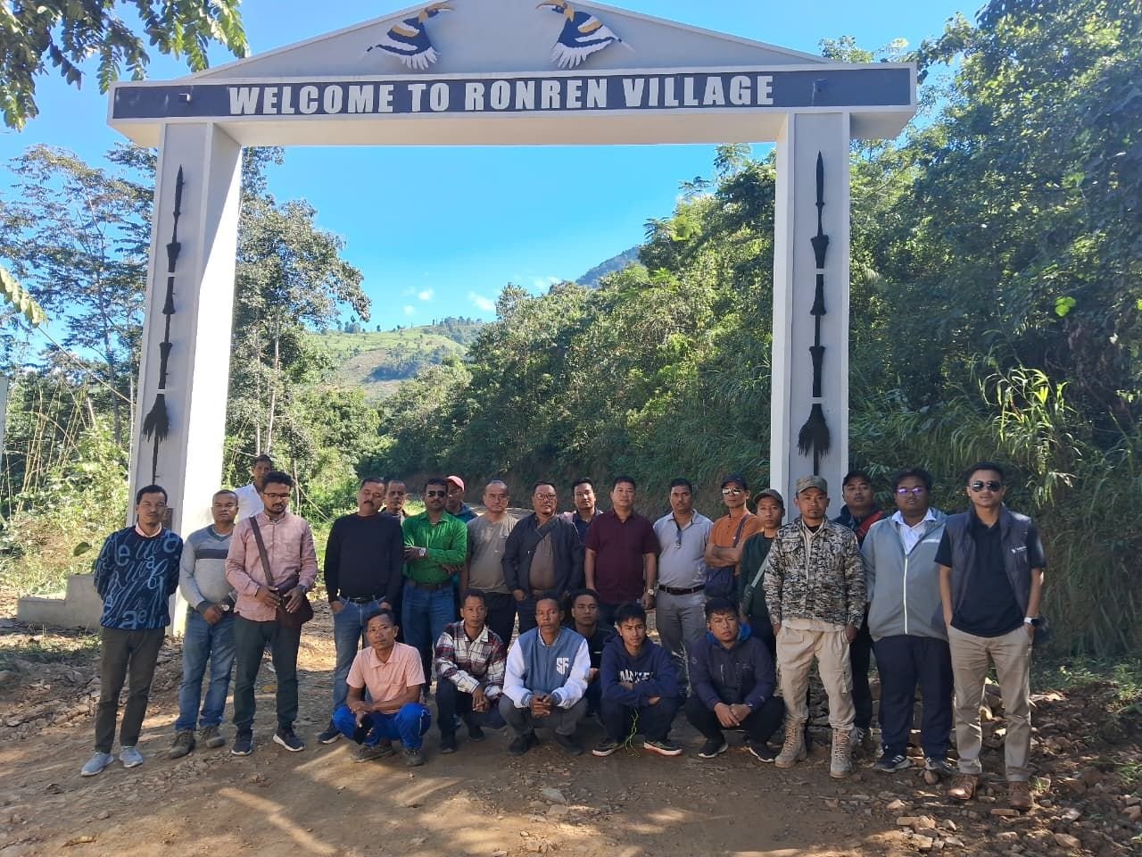 A delegation under the welcome gate of Ronren village