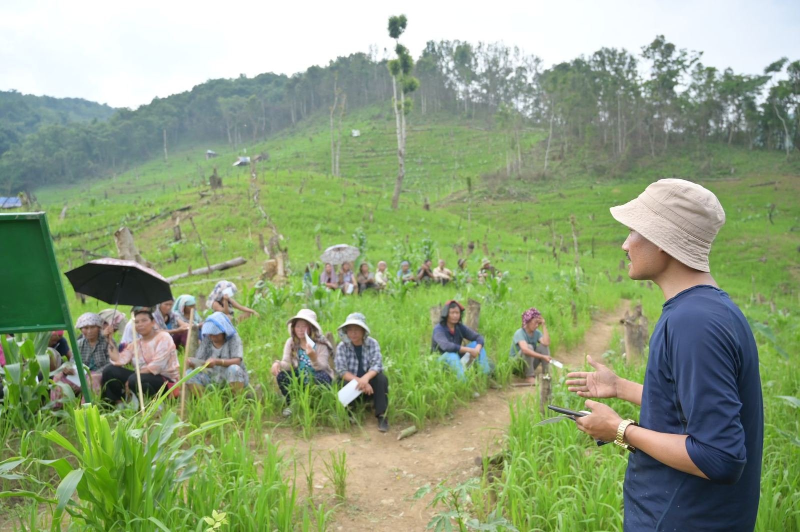 A facilitator addressing a seated community group