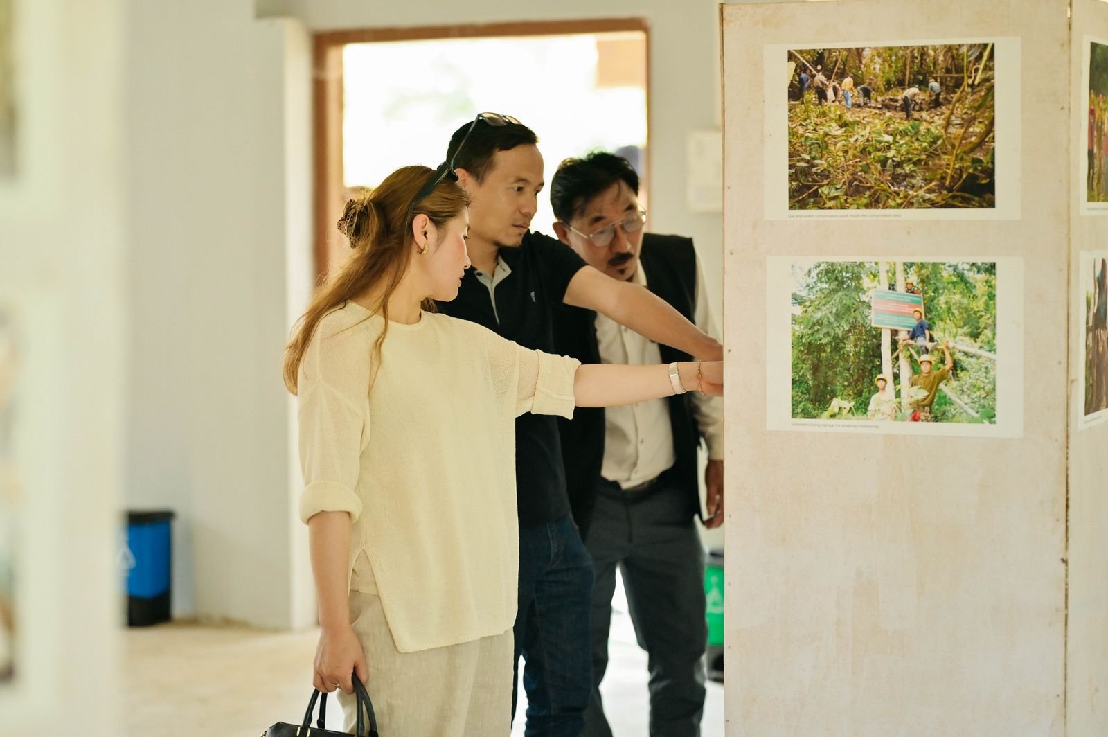 Visitors reading the photo panels on the reserve's conservation work inside the centre