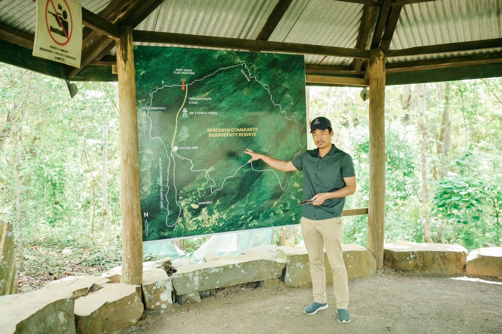 A guide pointing to the reserve map at the trailhead shelter
