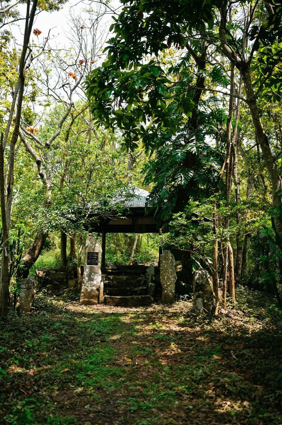Stone monoliths and a tin-roofed resting shed on the trail